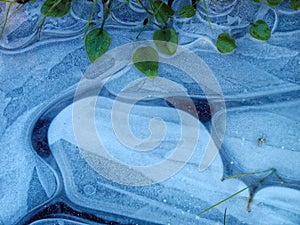 Blue ice frozen ground in winter abstract nature patterns