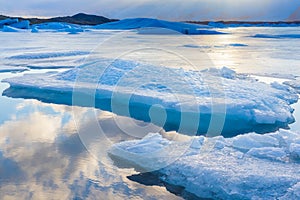 Blue ice floating in Iceland with sky reflexion