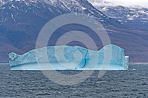 Blue Iceberg along a Remote Coast of Greenland
