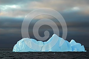 Blue iceberg with dark sky