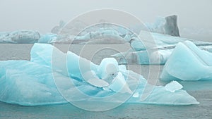 Blue iceberg in foggy glacier lagoon, pure Icelandic nature. Beautiful natural miracle in north country of winter and