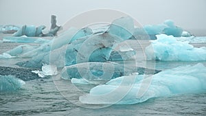 Blue iceberg in foggy glacier lagoon, pure Icelandic nature. Beautiful natural miracle in north country of winter and