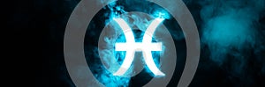 Blue illuminated Pisces zodiac sign with smoke