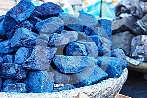 Blue indigo color stones displayed at traditional souk - street market in Marrakech, Morocco, closeup detail