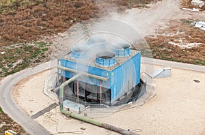 Blue industrial cooling tower at a chemical plant