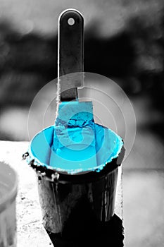 Blue ink in black bucket with enhanced color