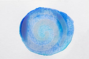 Blue ink blot on white canvas