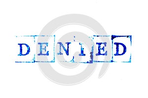 Blue ink of rubber stamp in word denied on white paper background