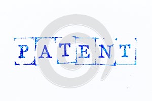 Blue ink rubber stamp in word patent on white paper background