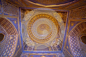 Blue interior with gold gild of Tile Karl Madrasa in The Registan, Samarkand, Uzbekistan