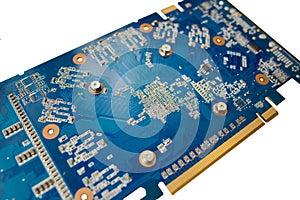 Blue isolated motherboard or computer boar with chips and component on it on a white background