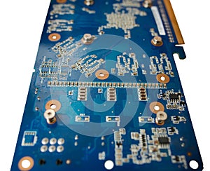 Blue isolated motherboard or computer boar with chips and component on it on a white background