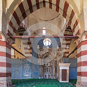 Blue Iznik ceramic tiles wall with engraved Mihrab niche and decorated marble Minbar Platform, Blue Mosque, Cairo, Egypt