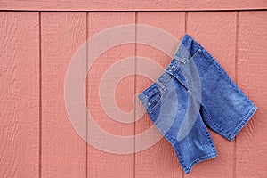 Blue Jean Capri Shorts on red wall