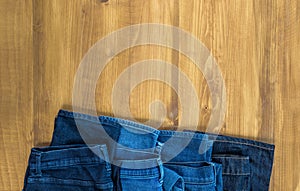 Blue jeans on a brown wooden background and Blue jeans denim Col