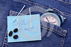 Blue jeans and clock with tag and a phrase coffee time