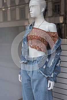 blue jeans clothes and floral printed  sexy top  on mannequin in women fashion store showroom