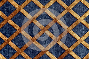 Blue jeans denim and gold fabric texture background with crosshatching or rhombuses.