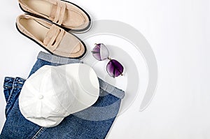 Blue jeans, gery hoody, beige suede loafer or flat shoes lying on white background