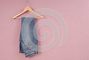 A blue jeans are on hanger. photo