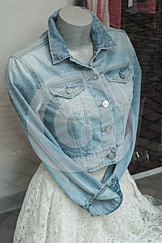 blue jeans jacket and white dress on mannequin in wom