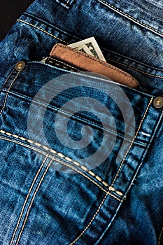 Blue jeans with leather wallet and US buck in a pocket.