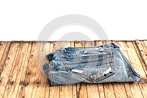 Blue jeans trouser roll up isolated on the wood