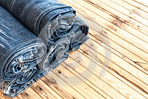 Blue jeans trouser roll up isolated on the wood