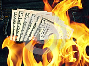 Blue jeans trousers pocket 50 american dollars and flames