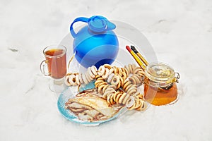 Blue jug and glass cup with beverage, bundles of photo