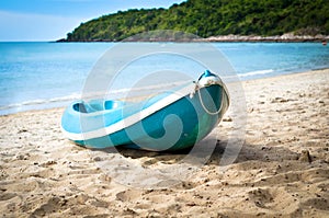 Blue kayak on sandy beach