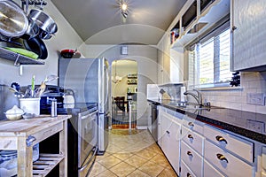 Blue kitchen interior with brown tile and stainless steel refrigerator