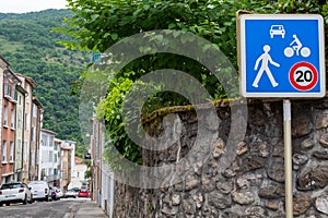 Blue 20km h Home Zone speed limit sign showing car, bicycle and pedestrian in French street photo