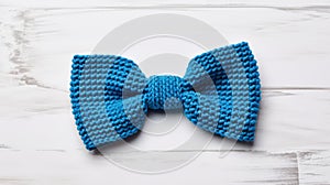 Vivid Blue Knit Bow Tie On White Wood Table photo