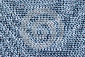 Blue knitted fabric texture. Rough sweater background