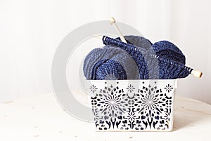 Blue knitting wool balls in wicker basket