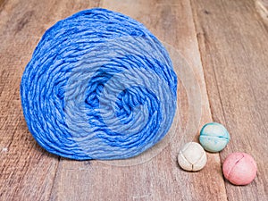 Blue knitting yarn on wooden background