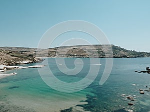Blue lagon beach at Gozo island with floating boat