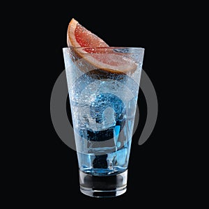 Blue lagoon cocktail with Blue Curacao liqueur in a tall glass isolated on black background. Classic alcoholic cocktail