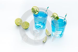 Blue lagoon cocktail drink with lemon juice and mint leaves