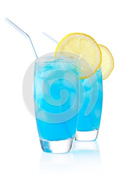 Blue lagoon cocktails with slice of lemon with straw isolated on white