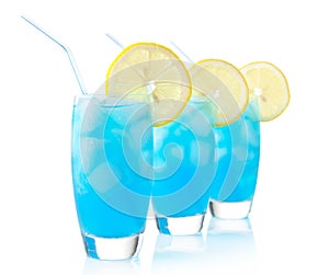 Blue lagoon drinks with slice of lemon with straw on white