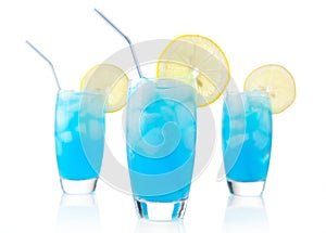 Blue lagoon drinks with slice of lemon with straw on white