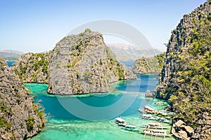 Blue lagoon with longtail boats by Karangan Lake in Coron Palawan - Beautiful tropical destination in Philippines - Travel photo