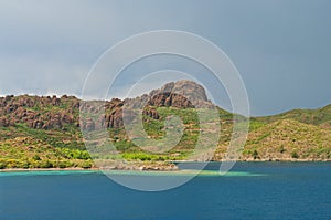 Blue lagoon surrounded by mountains and plants