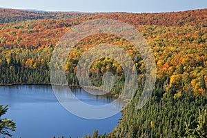 Blue lake amid colorful fall trees in Minnesota photo