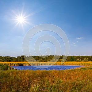 blue lake among prairie at the summer sunny day