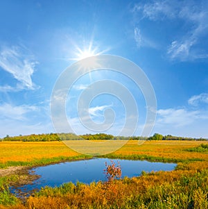 blue lake among prairie under a sparkle sun