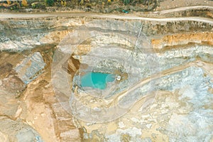 A blue lake in a quarry, an orange-colored sand quarry from a bird`s eye view