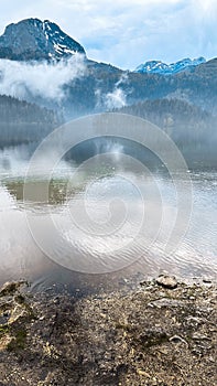 blue Lake with the reflection of needle leaf trees and mountains